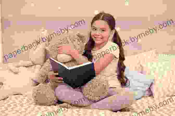 A Young Child Sitting On A Bed And Reading A Book While Smiling And Sitting Next To A Teddy Bear The One Year Devotions For Kids #2 (One Year Book)