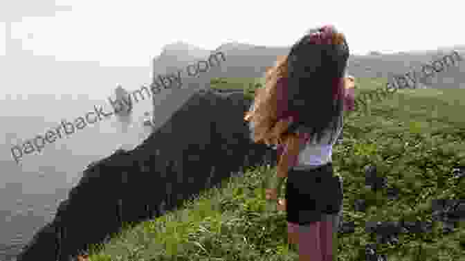 A Young Girl Standing On A Cliff, Gazing Out At A Herd Of Horses Galloping Across A Grassy Plain On The Island Of Lost Horses. The Island Of Lost Horses