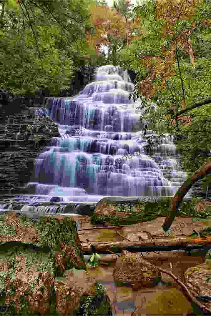 Cascading Waters Over A Rocky Bluff, Surrounded By Lush Greenery, With A Blue Sky And White Clouds Above North Carolina Waterfalls Kevin Adams