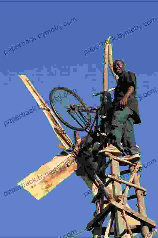 Determined Boy Constructing Windmill Against Vibrant African Sunset The Boy Who Harnessed The Wind: Young Readers Edition