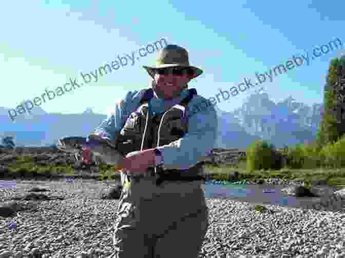 Fly Fisherman Casting In The Snake River, Wyoming, With The Teton Mountains In The Background. Flyfisher S Guide To Wyoming Ken Retallic