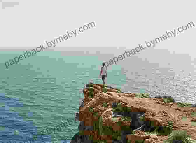 Tristan Jones Standing On A Cliff Overlooking The Ocean The Incredible Voyage Tristan Jones